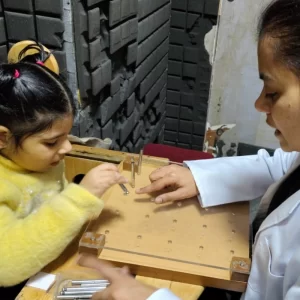 Special therapist guiding a child in an occupational therapy game to enhance sensory processing and motor skills.